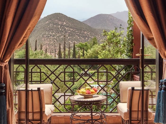 A quiet terrace framed by curtains, looking out to the Atlas Mountains.