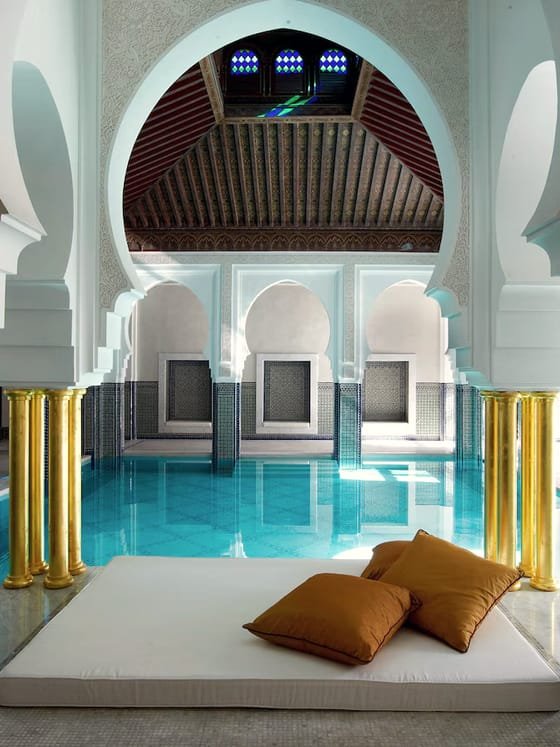 The arched pool and stone columns of a traditional hammam.